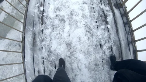 Two men walk across the bridge in the winter, first-person shots. POV. Stock Footage 103868992