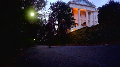 Two men walk out of a dark alley in a wealthy neighborhood Stock Footage 43102145