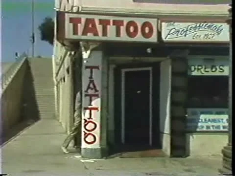 Two Men Walk Into Tattoo Parlor Stock Footage 10849247