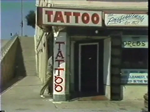 Two Men Walk Into Tattoo Parlor Stock Footage 69714627