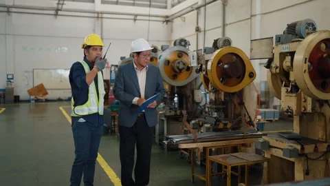 Two men walk through a factory floor Stock Footage 341651637