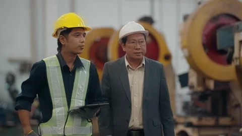 Two men walk through a factory floor Stock Footage 341653230