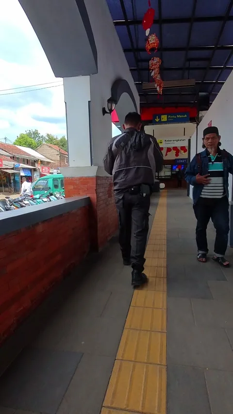 Two men walk through a station entrance. Stock Footage 340960603