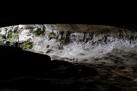 Two men walking along pathway in the Milondon Cave, Puerto Natales, Patagonia Stock Photos