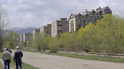 Two men walking along a road in Dilijan, Armenia Stock Footage 191915161
