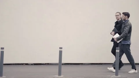 Two men walking and talking on the street. Video stock 152044652