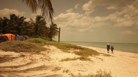 Two men walking on a beautiful wild beach by the camp Video stock 39617851