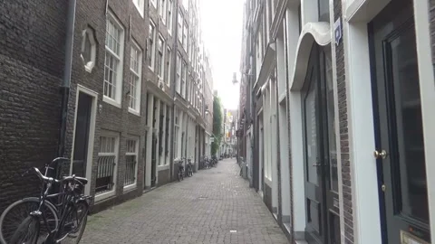 Two men walking between two houses Stock Footage 94832113