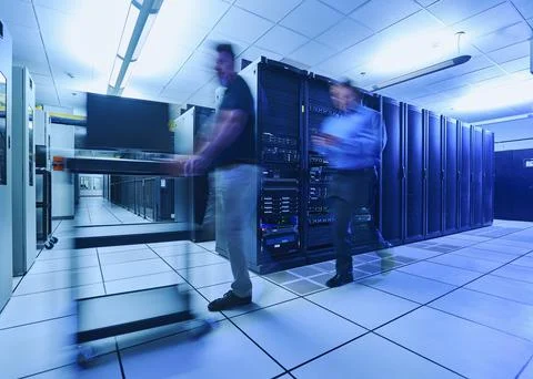 Two men walking in data center Stock Photos