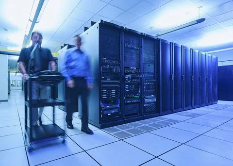Two men walking in data center Stock Photos