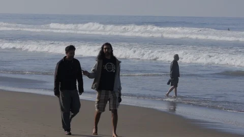 Two Men Walking Down The Beach - Silhouette Stock Footage 97755301