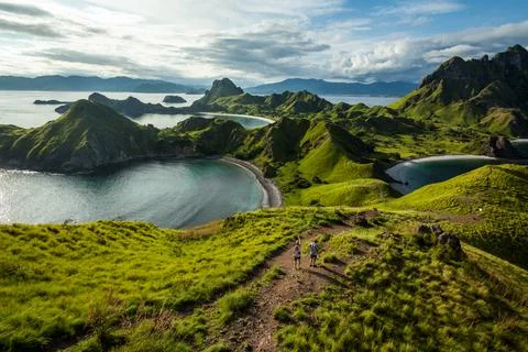 Two men walking down the hill of Padar island Stock Photos