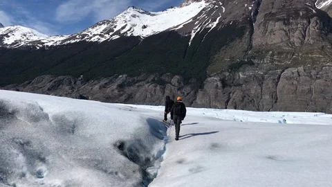 Two men walking on Glacier Grey, Torres del Paine National Park, Chile 動画素材 95677835