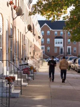 Two men walking on sidewalk Foto stock