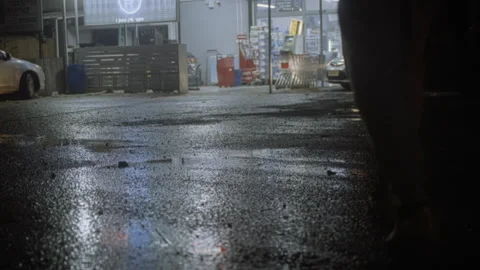 Two men walking toward a grocery store carrying a bat and a gun at night Stock Footage 275172635