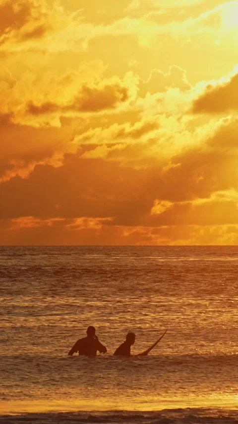 Two men in a water looking the sunset Stock Footage 300425065