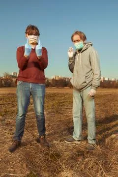 Two men wearing protective face mask on public park city location Stock Photos