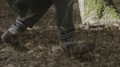 Two men wearing stilettos and feathers on their shoulders fleeing through th Stock Footage 166316356