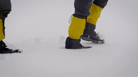 Two men went on an expedition. Professional trekking boots and leggings help to Stock Footage 106582078