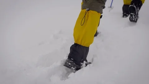 Two men went on an expedition. Professional trekking boots and leggings help to Stock-Footage 106582147