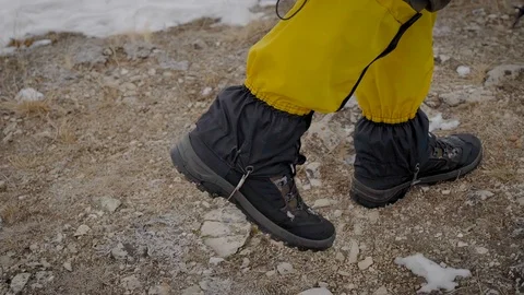 Two men went on an expedition. Professional trekking boots and leggings help to Stock Footage 106582830