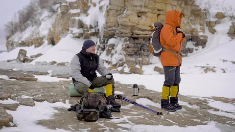 Two men went on a winter hike. Friends have professional equipment, they walk Stock Footage 106582277