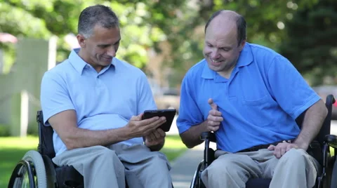 Two men in wheelchairs in a park. Stock Footage 64827277