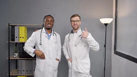 Two men in white lab coats looking at camera Stock Footage 276224252