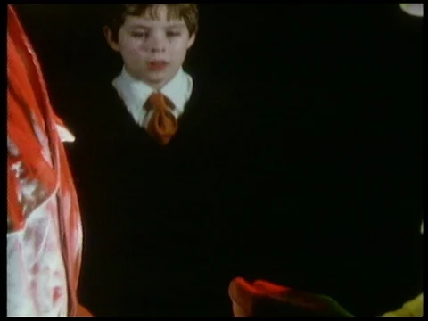 Two men in white masks talking to boy, then observing small object, 1985 Stock Footage 136674247