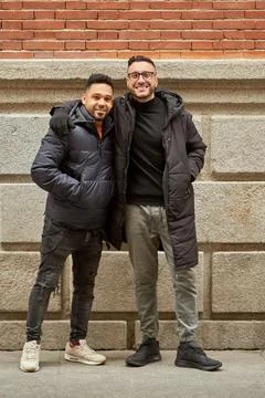 Two men in winter clothes looking at camera and smiling while posing together Fotos Stock