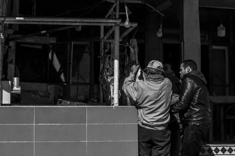 Two men work with the meat, black and white Stock Photos