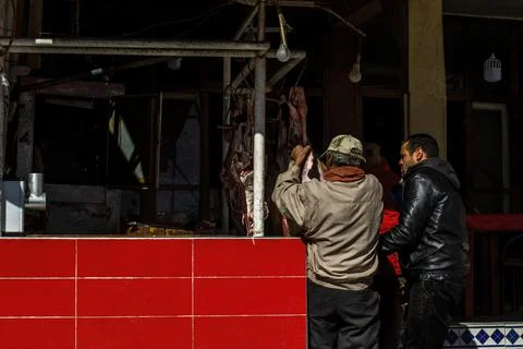 Two men work with the meat Stock Photos