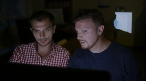 Two men work at night over the project plan of construction the house Stock Footage 58015515