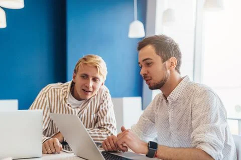 Two men work in office using laptop Stock Photos