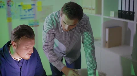 Two men work overtime at office Stock Footage 62550187