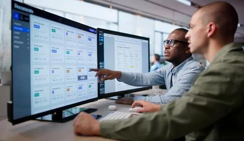 Two Men Work Together Managing Secure Digital Documents Using Advanced Softwa 스톡 사진