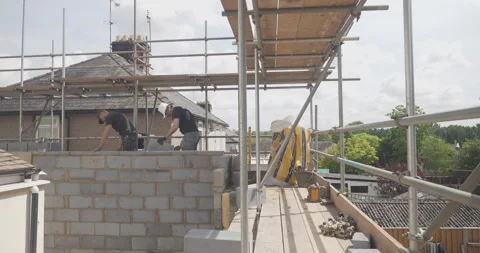 Two men working on a building site wide shot Video stock 246381137