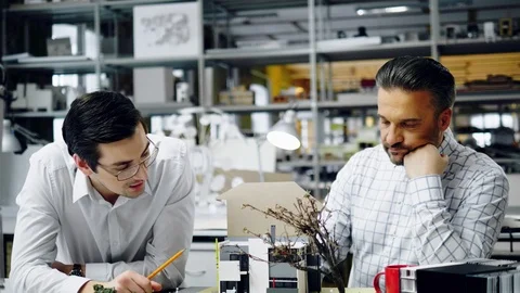 Two men working in design and engineering architecture office Stock Footage 85877891