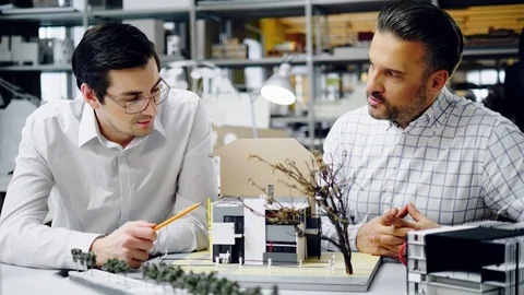 Two men working in design and engineering architecture office Stock Footage 85877903