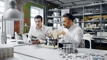 Two men working in design and engineering architecture office Stock Footage 85877909
