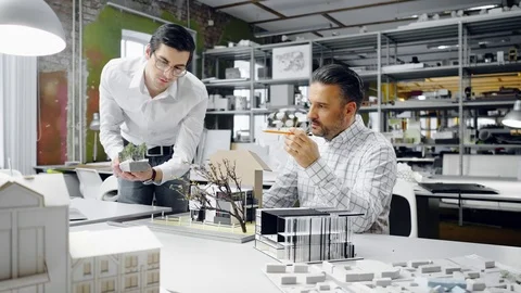 Two men working in design and engineering architecture office Stock Footage 86361981