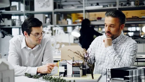 Two men working in design and engineering architecture office Stock Footage 86791656