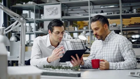 Two men working in design and engineering architecture office Stock Footage 86792659