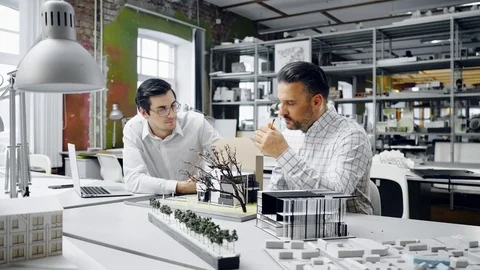 Two men working in design and engineering architecture office Stock Footage 86795401