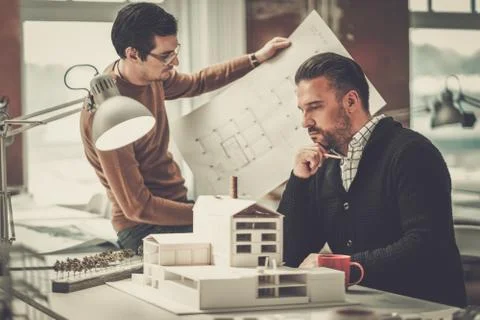 Two men working in design and engineering architecture office. Stock Photos
