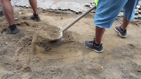 Two men working, repair the sidewalk, with a pickaxe and a shovel Stock Footage 159020018