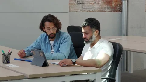 Two men working as a team in an office or coworking with a laptop Stock Footage 162353280