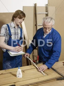 Two men working in a wood workshop Stock Photos