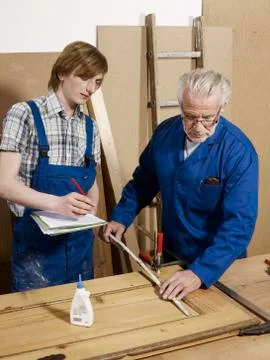 Two men working in a wood workshop Stock Photos