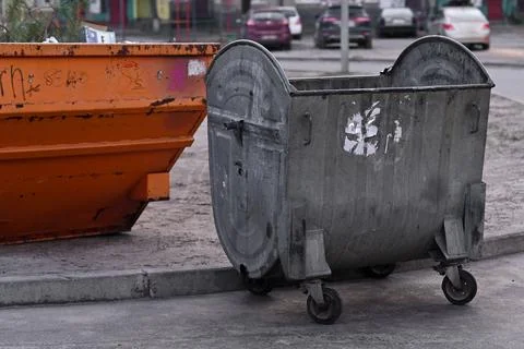 Two metal garbage cans. unsorted garbage. Unsorted garbage. in city yard Stock Photos